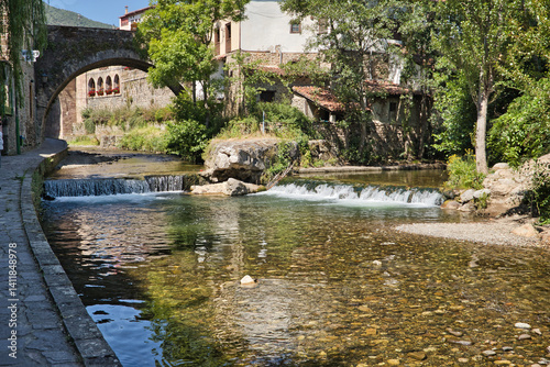 Принти на полотні Waterfalls in the Quiviesa river as it passes through the town of Potes in the peaks of Europe, which is approaching its end, flowing a few meters downstream into the Deva river