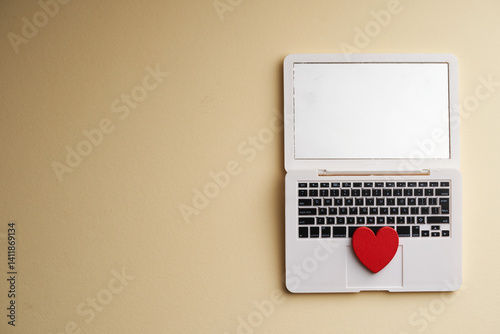 red heart shape and miniature laptop