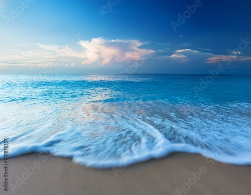 Soft blue ocean wave on fine sandy beach, close up