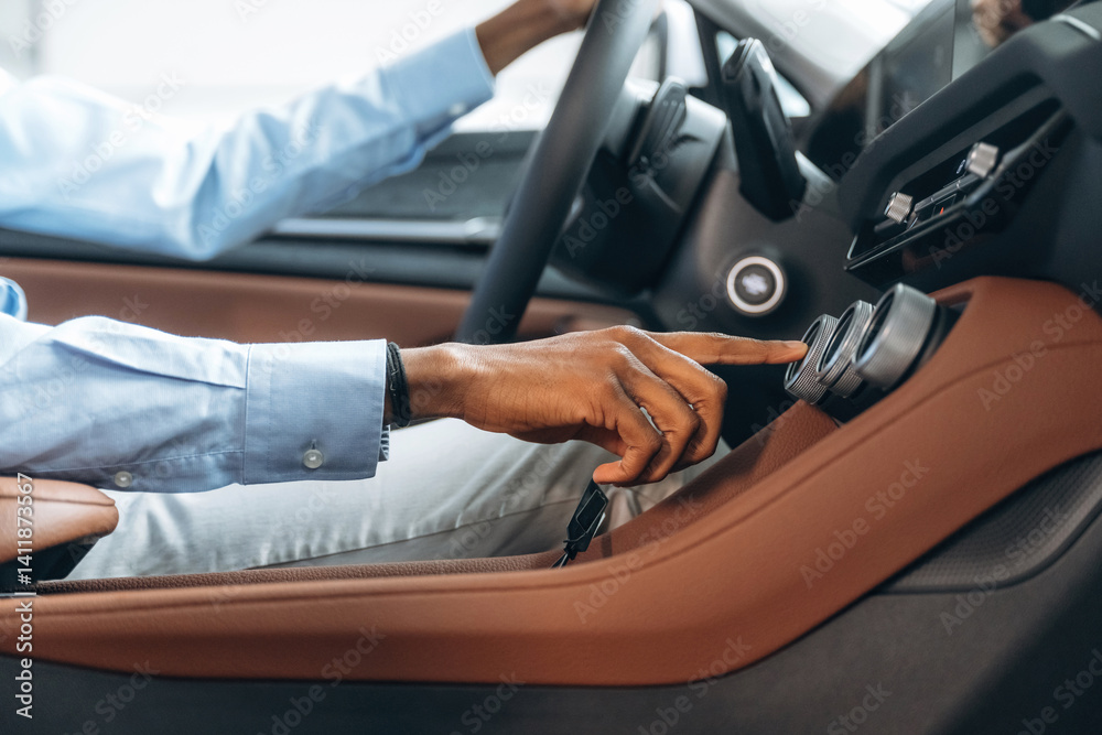 Pushing the button. Man in shirt is in the modern car Pushing the button. Man in shirt is in the modern car