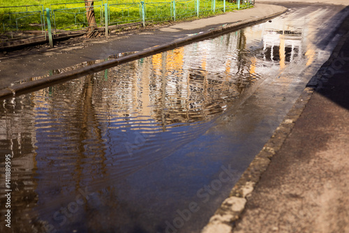 A large puddle between the sidewalks