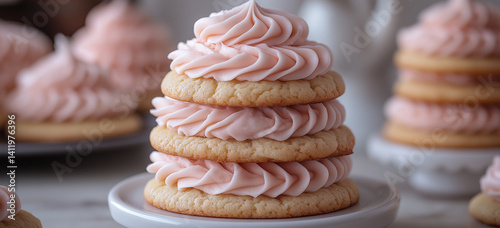Stack of glazed cookies with pink cream filling on pastel background