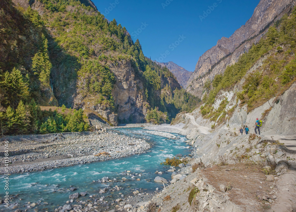 Himalayas, Nepal - The famous hiking on the roof of the world called Annapurna Circuit in the Himalaya range mountain, with little village, buddhist stupa and mountains of 8000 meters.