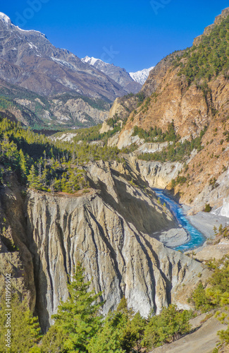Himalayas, Nepal - The famous hiking on the roof of the world called Annapurna Circuit in the Himalaya range mountain, with little village, buddhist stupa and mountains of 8000 meters.