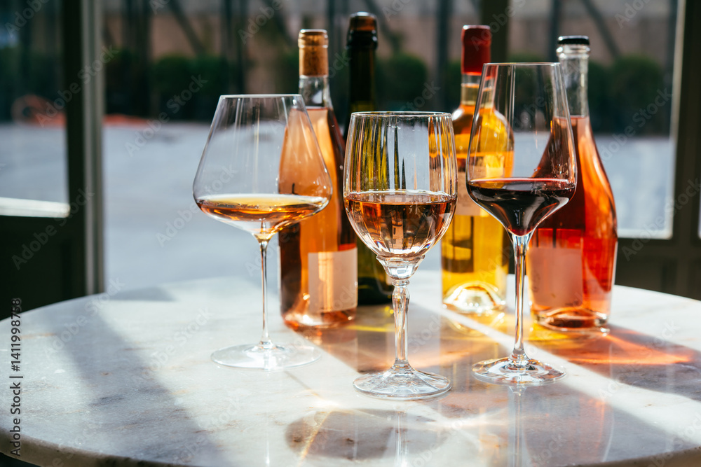 Different types of wine in glasses - red, white, rose and amber. Wine tasting in a bar or restaurant.