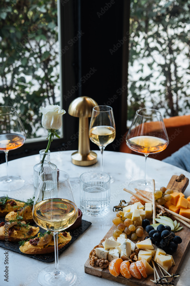 Friends having a dinner party with different kinds of appetizers and wine.