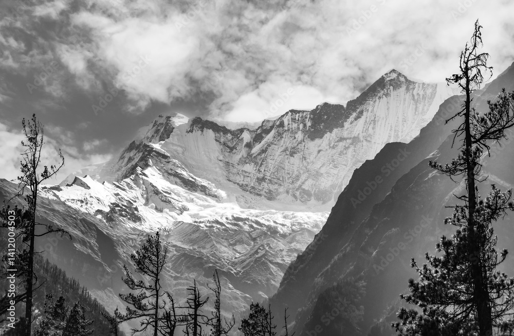 Himalayas, Nepal - The famous hiking on the roof of the world called Annapurna Circuit in the Himalaya range mountain, with little village, buddhist stupa and mountains of 8000 meters.