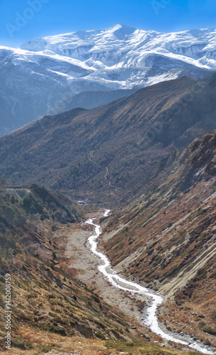 Obraz na płótnie Himalayas, Nepal - The famous hiking on the roof of the world called Annapurna Circuit in the Himalaya range mountain, with little village, buddhist stupa and mountains of 8000 meters. w salonie