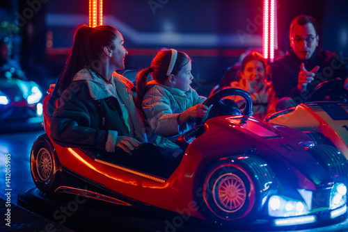 Wallpaper Mural Mother and daughter enjoying bumper cars at amusement park Torontodigital.ca