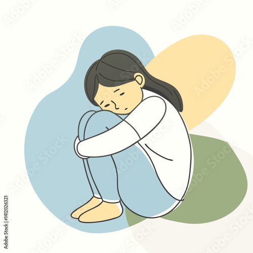 a girl with a hugging knees while frowning