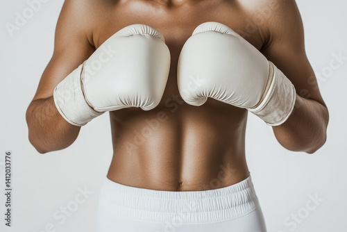 A muscular woman's torso, bare except for white boxing gloves, displays strength and fitness.