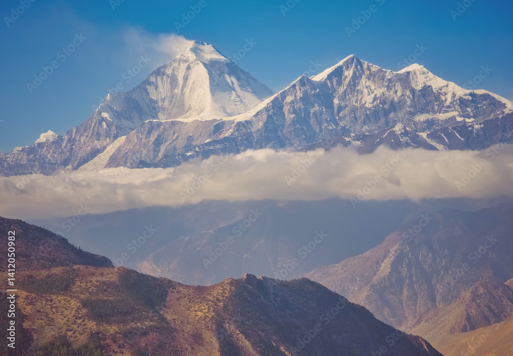 Himalayas, Nepal - The famous hiking on the roof of the world called Annapurna Circuit in the Himalaya range mountain, with little village, buddhist stupa and mountains of 8000 meters.
