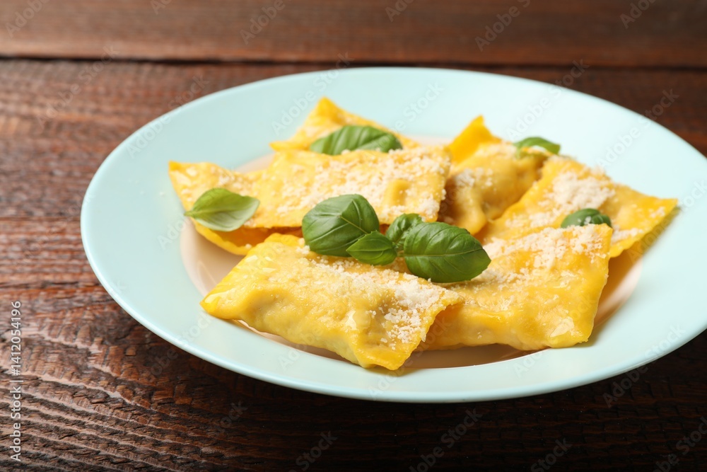 Delicious ravioli with cheese and basil on wooden table, closeup Delicious ravioli with cheese and basil on wooden table, closeup