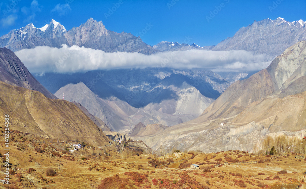 Himalayas, Nepal - The famous hiking on the roof of the world called Annapurna Circuit in the Himalaya range mountain, with little village, buddhist stupa and mountains of 8000 meters.