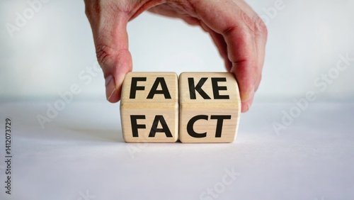 Hands holding Scrabble tiles spelling out 'Fake Facts'. photo