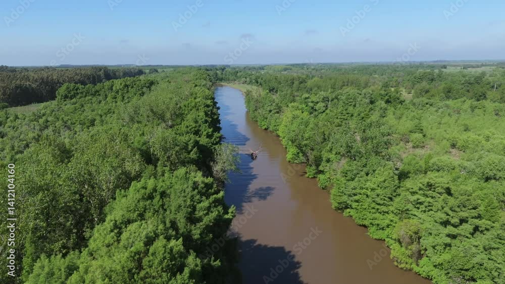 Fast boat navigating winding river in subtropical forest, aerial view Fast boat navigating winding river in subtropical forest, aerial view