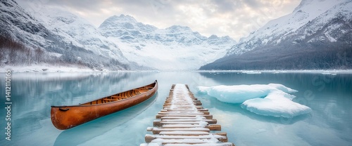 Obraz na płótnie Winter serenity on a glacial lake. A canoe rests on the still waters, a wooden pier leads to a frozen expanse w salonie