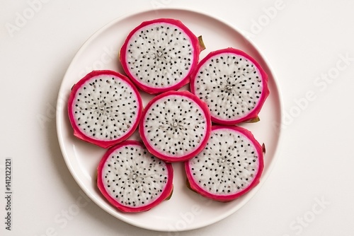 Bright Dragon Fruit Slices Arranged on a White Plate Showcasing Vibrant Color...