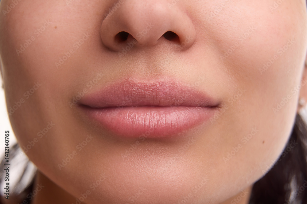 Cropped close-up image of spotless female face, plump natural lips. Lip augmentation, beauty products, hydration. Concept of beauty, cosmetology, cosmetics, skin care, makeup