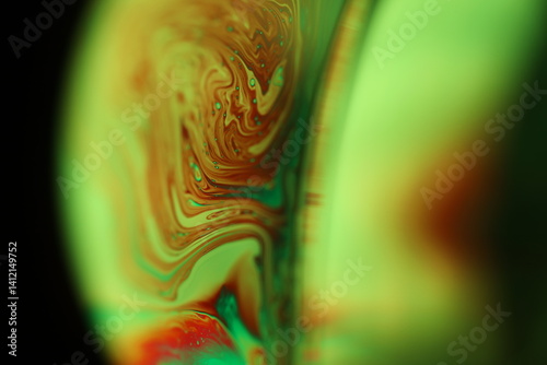 Green Reflections of liquid in macro, green liquid surface, bubbles in macro, connection of bubbles in macro, cell from liquid, dark background, glossy surface
