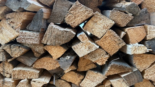 Firewood (wooden background) close-up stacked in a woodpile