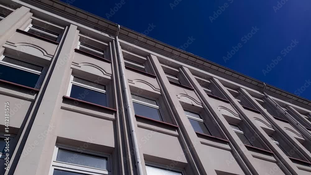 Concrete plastered building with windows, with afternoon sun. Modern building, urban architectural structure. Concrete plastered building with windows, with afternoon sun. Modern building, urban architectural structure.