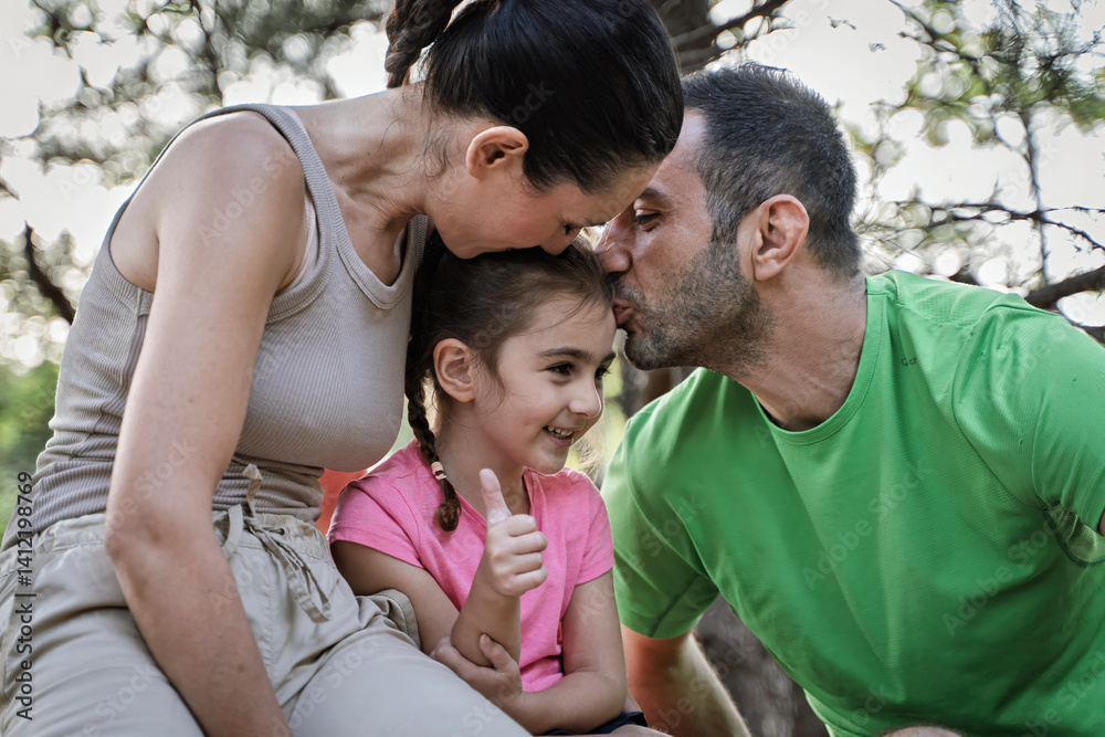 Loving family showing affection to happy daughter during forest walk bonding moment Loving family showing affection to happy daughter during forest walk bonding moment