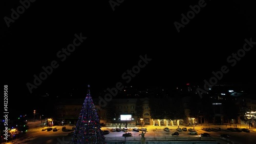 Drone shot of the illuminated Christmas tree at Vardanants Square at night in Gyurmi city, Armenia photo