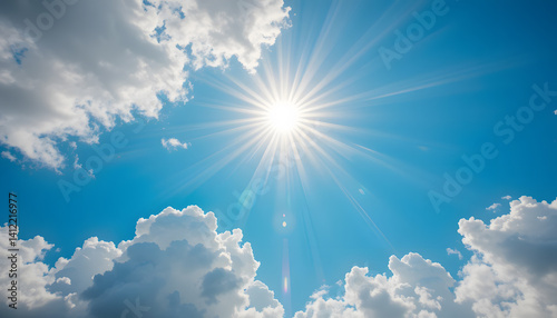 Bright Sunburst and Clouds in Clear Blue Sky
