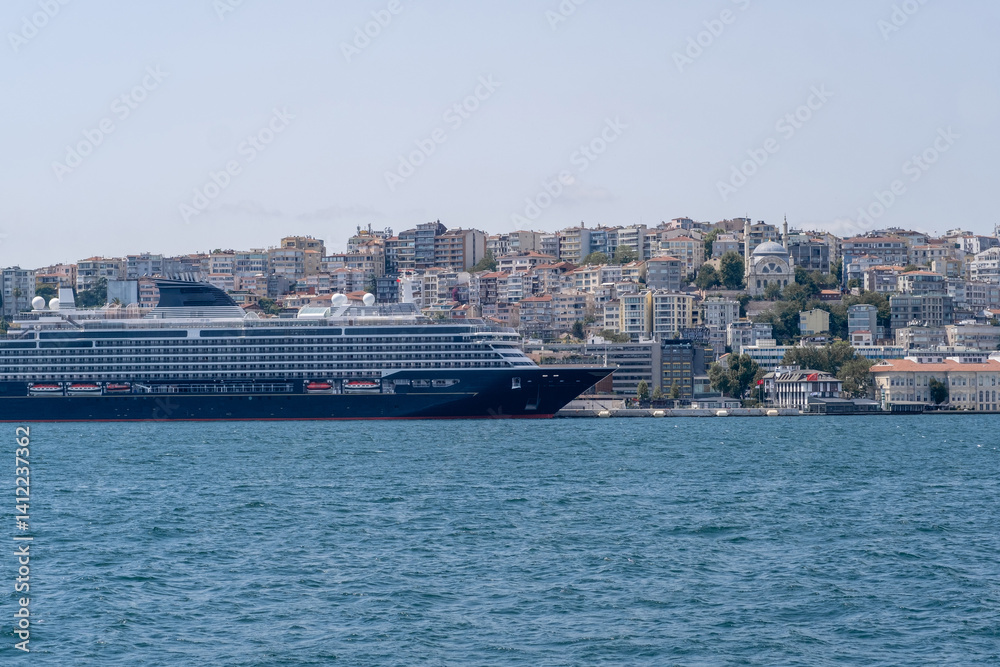 Cruise ship anchored in the Bosphorus with city views on a clear day Cruise ship anchored in the Bosphorus with city views on a clear day