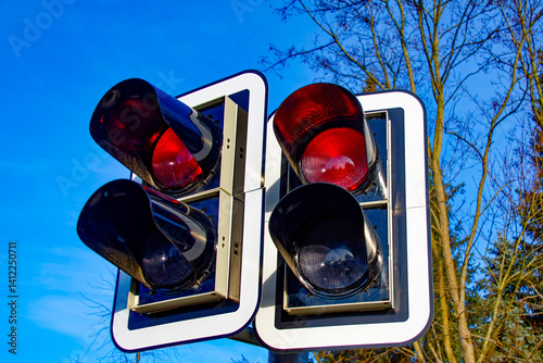 Two traffic lights, both displaying a red warning signal.