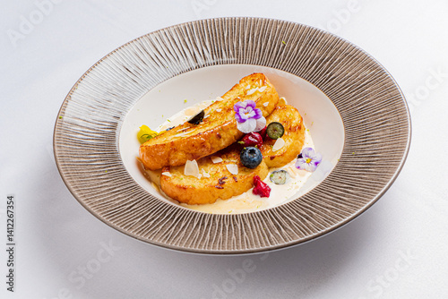 Fototapeta Naklejka Na Ścianę i Meble -  A vibrant dessert features roasted fruit, berries, and edible flowers for a culinary delight