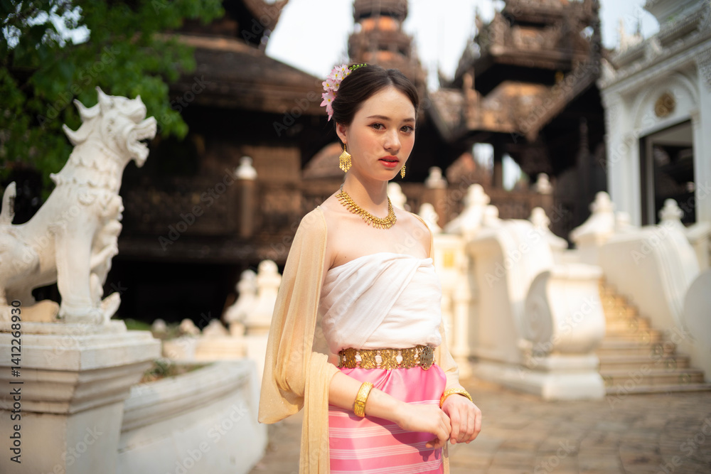 Beautiful young Asean woman in traditional Thai Dvaravati dress in an old temple in Chiang Mai, Thailand.