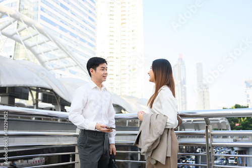 Canvas Print Business partners discussing during a meeting outdoors in Bangkok