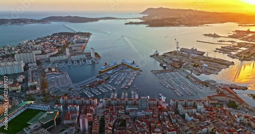 Aerial view of port city on the mediterranean coast of southern France. Aerial view of Toulon with ships and boats by the Marina Port with colourful houses. Beautiful buildings and colourful houses