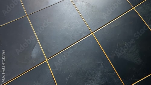 Elegant dark tiles with golden grout lines arranged diagonally in a modern interior setting