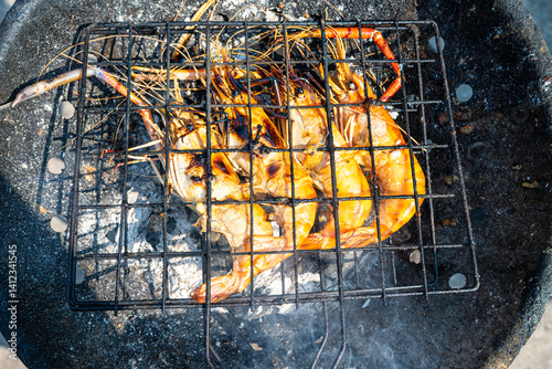 Big river prawn shrimp grilled on fire with smoke