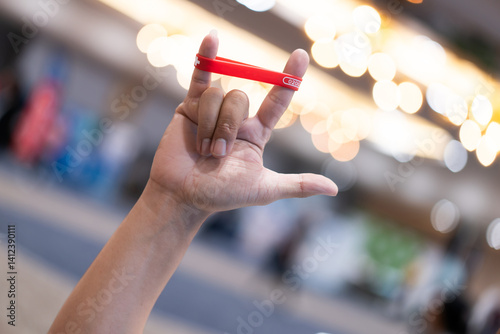 Hands make a love symbol with a wristband