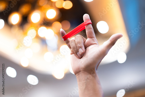 Hands make a love symbol with a wristband