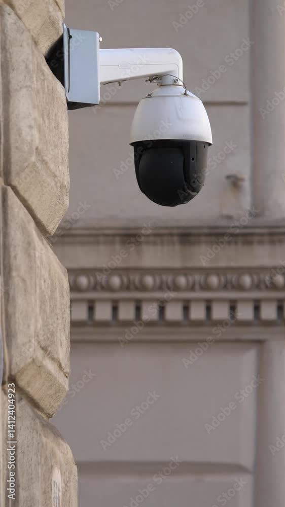 A discreet security camera is installed on the facade of an old Roman ...