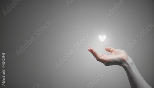 Hand holding glowing heart symbol on neutral background  