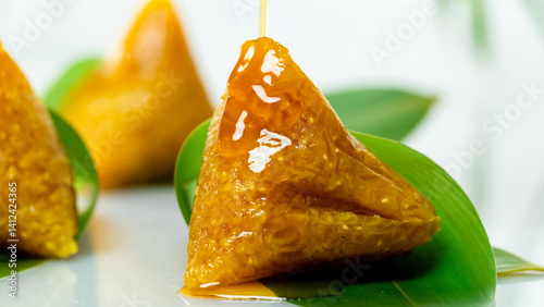 lye rice dumplings, honey, syrup, sweet, cantonese style, rice dumplings, glutinous rice, snack, dessert, cuisine, cuisine, close-up, three, leaves, golden, glossy, traditional, chinese, asian, orient