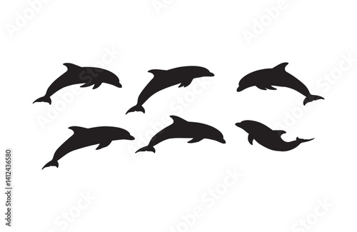 Graceful silhouettes of dolphins diving in blue waters