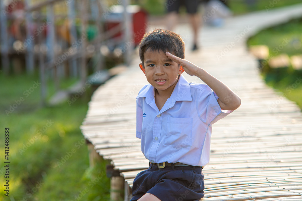 Asian school boy relax in city public park leisure time sunset light