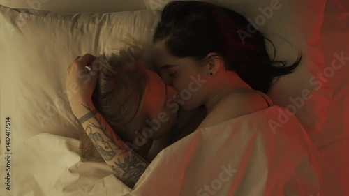 Top view young loving couple romantic time in bedroom. Man and woman half naked sensual lovers laying in bed together, passion, intimacy kissing, foreplay and bonding.