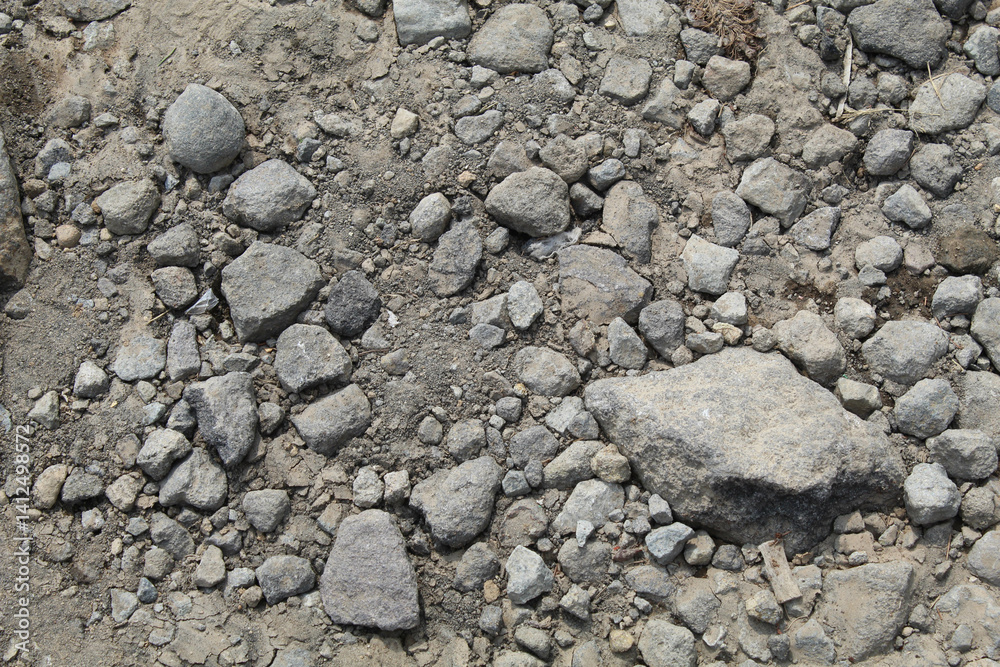 Crushed grey stones and sand background, flat lay or top view Crushed grey stones and sand background, flat lay or top view