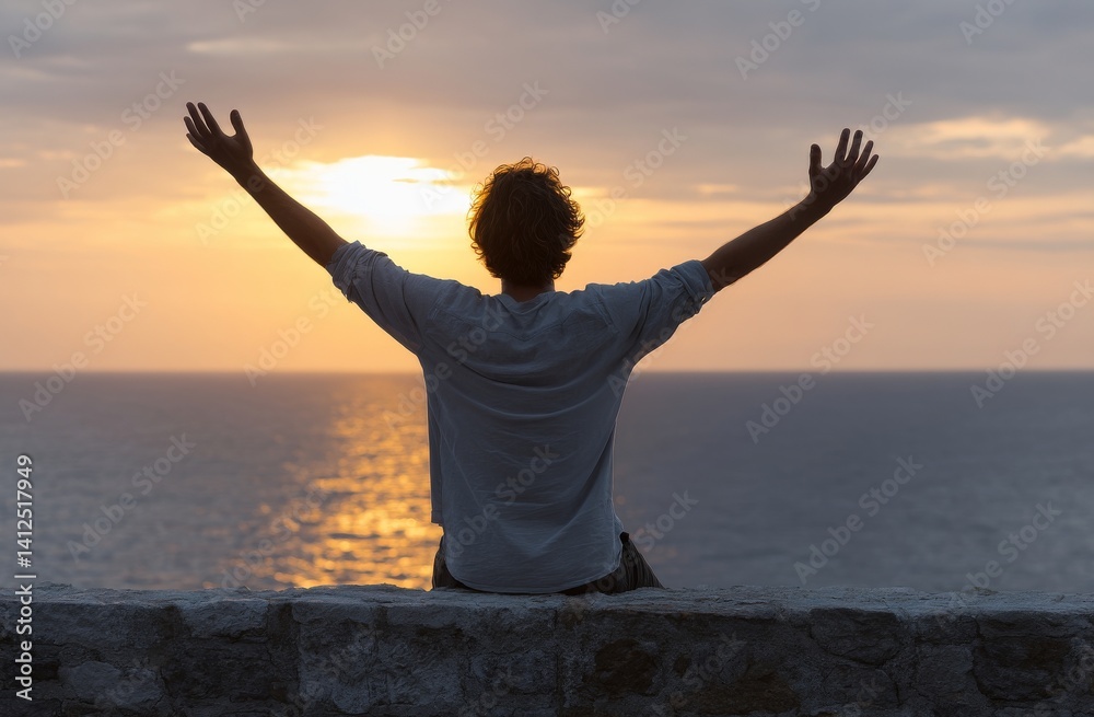 Fototapeta premium At the edge of the mountain, a sense of inspiration and hope washes over the young man as he looks out to the rising sun