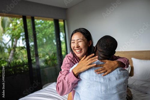 Interracial couple enjoying a joyful and intimate moment, embracing love, laughter, and togetherness