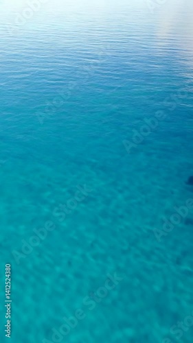 Vast Turquoise Ocean with Gentle Ripples Reflecting the Sky Above
