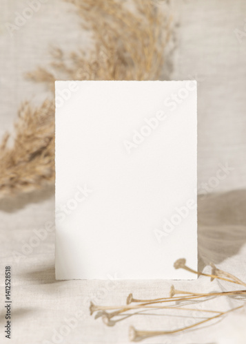 Obraz na płótnie Blank card near dry beige pampas grass on linen closeup, mockup. Bohemian wedding stationery w salonie